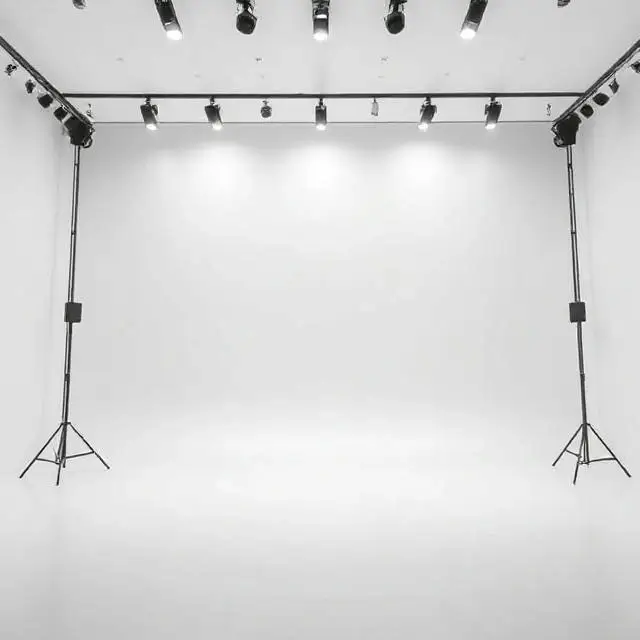 A vast, clean white cyclorama wall in The Cyc Infinity studio.